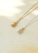 Perfume bottle necklace / emiru logo